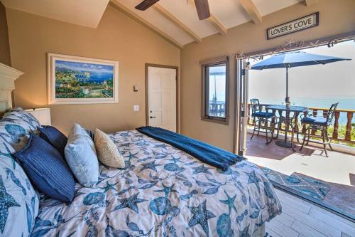 a bedroom with a bed and a table with an umbrella at Lux Oceanfront Villa With Breathtaking Views in Avalon