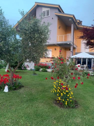 a house with a lot of flowers in the yard at Hotel Villa Linda in Shkodër