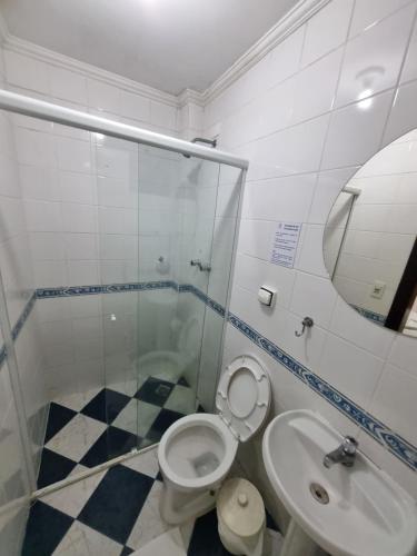 a bathroom with a shower and a toilet and a sink at Camping Pousada Ilha do Mel - Frente ao Mar in Boracéia