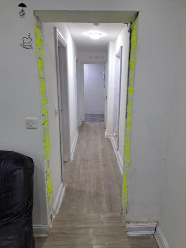 a hallway in a house with yellow tape on the walls at 2 Bed apt 1 kitchen 1 Bath in Birmingham