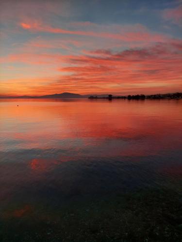 a sunset over a large body of water at Platanidia Apartment Pelion in Platanidia