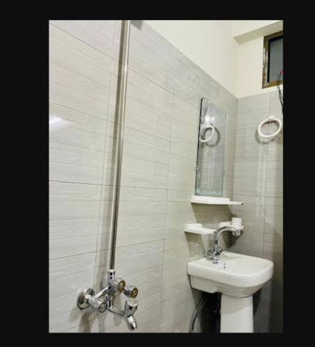 a bathroom with a shower and a toilet and a sink at River Vibes Guest House in Muzaffarabad