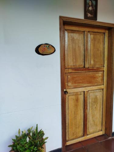an open wooden door in a room with a plant at Hotel MAXIRUMA - Villa TAMAUKA in Iza