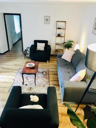 a living room with a couch and a table at Gîte des Canelles in Villespy