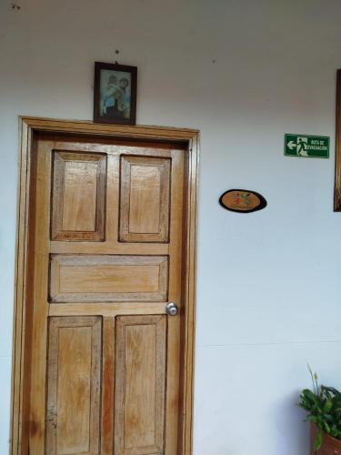 a wooden door in a room with a picture on the wall at Hotel MAXIRUMA - Villa TAMAUKA in Iza