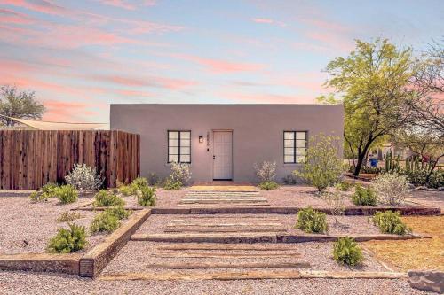 a home with a pathway leading to the front door at Cute & Cozy 2BR 1BA Adobe w Firepit Near UA & UMC in Tucson
