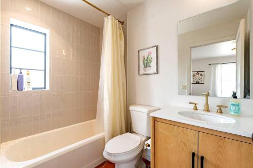 a bathroom with a sink and a toilet and a tub at Cute & Cozy 2BR 1BA Adobe w Firepit Near UA & UMC, Low Summer Rates! in Tucson