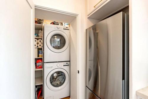 a laundry room with two washer and dryer at Cute & Cozy 2BR 1BA Adobe w Firepit Near UA & UMC in Tucson