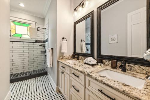 a bathroom with a sink and a mirror at Stunning Uptown 3 Bedroom 3 Bathroom home in New Orleans