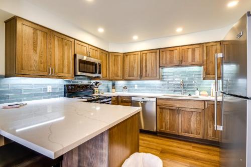 a kitchen with wooden cabinets and a white counter top at Hot Tub Access Bright Breckenridge Condo in Breckenridge