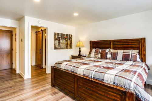 a bedroom with a large bed with a wooden headboard at Hot Tub Access Bright Breckenridge Condo in Breckenridge