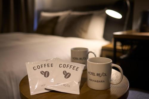two coffee mugs on a table in a hotel room at Hotel Resol Akihabara in Tokyo