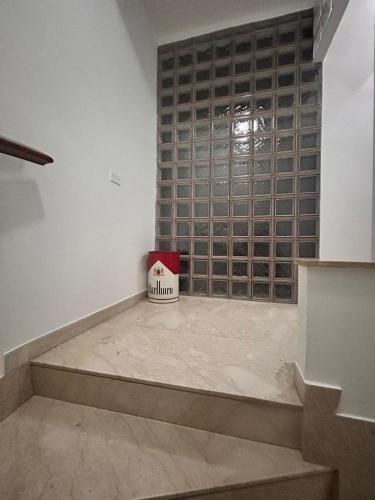 a room with a staircase with a wooden wall at Luxury Studio Suite in Niscemi