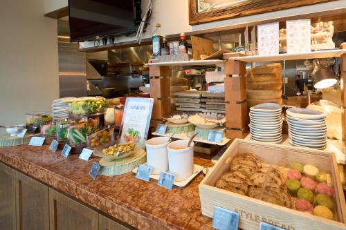 a buffet line with food on a counter in a restaurant at Hotel Resol Akihabara in Tokyo