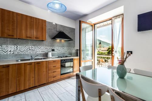 a kitchen with a glass table with chairs and a window at Agritur Michelotti Giancarlo in Arco