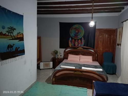 a bedroom with a bed and a painting on the wall at Roof of Comfort & Calm in Maadi in Cairo
