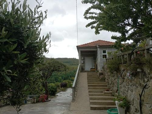 a house with stairs leading up to it at Casa das Leiras in Loivos da Ribeira