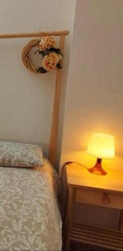 a lamp on a table next to a bed at Folià Bed and Relax in Benevento