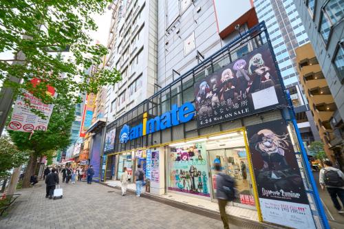 a street with people walking in front of a store at Hotel Resol Akihabara in Tokyo