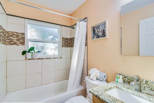 a bathroom with a tub and a toilet and a sink at Lovely St Petersburg Home with Backyard Oasis in St Petersburg