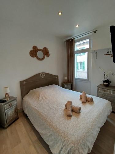 une chambre avec un lit avec deux ours en peluche dessus dans l'établissement 2 pièces Cannes centre, à Cannes