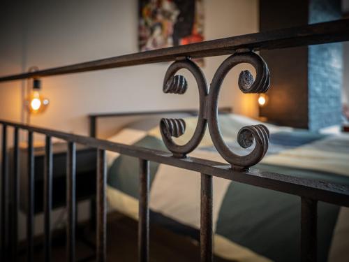a iron fence with a bed in the background at B³/ 201 in Bertrix