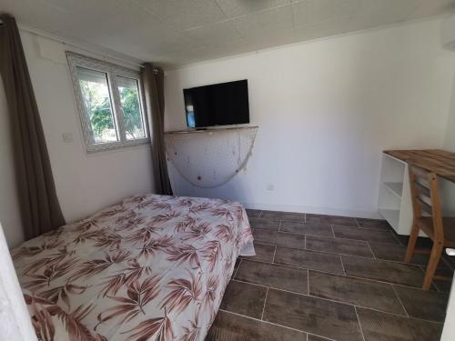 a bedroom with a bed and a flat screen tv at Calanques Prado Stade et Parking in Marseille