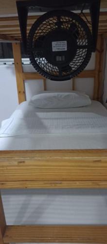 a bed with two pillows on top of it at Hostal Palo Alto in San Andrés
