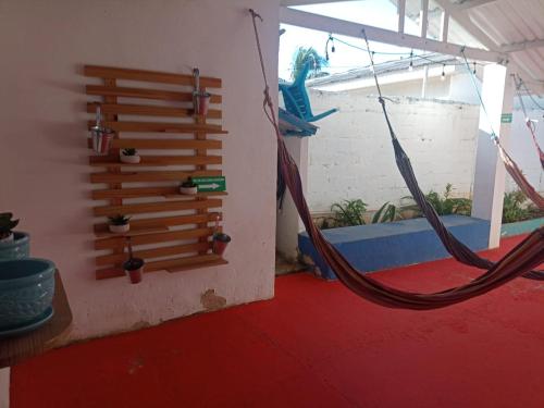 a room with a hammock hanging from a wall at Hostal Palo Alto in San Andrés