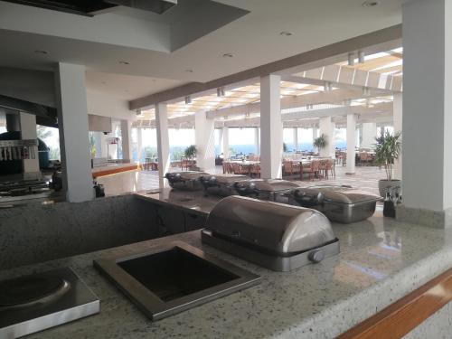 a kitchen with a counter with a bunch of chairs at Chalet NEMO, vista mare, Sharks Bay, Sharm el Sheikh in Sharm El Sheikh