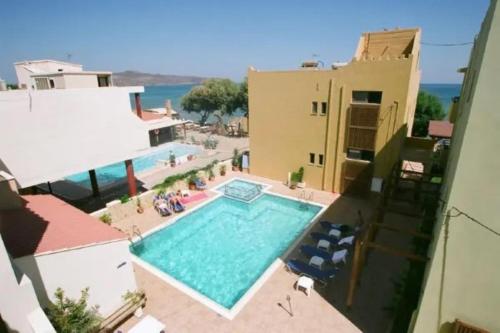 a swimming pool in the middle of a building at Faros Vetoula Suites in Stalos