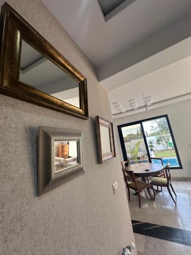 a living room with a mirror and a table at Coquette villa avec piscine in Tunis