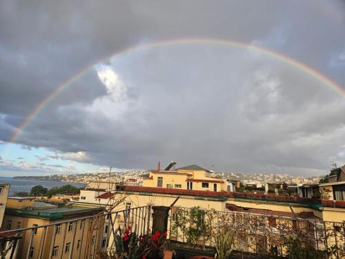 a rainbow in the sky over a city at La casa di Nettuno in Naples