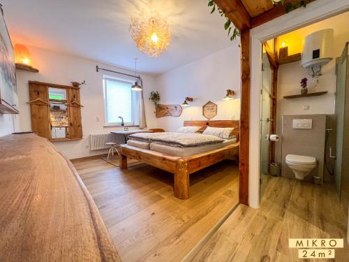 a bedroom with a bed and a bathroom at Altstadt Apartments in Neuruppin