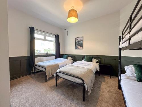 a room with three beds and a window at The Bunker - Garesfield Golf Course in Newcastle upon Tyne