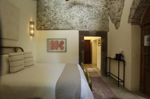 a bedroom with a white bed in a room at Orchid House San Miguel de Allende in San Miguel de Allende