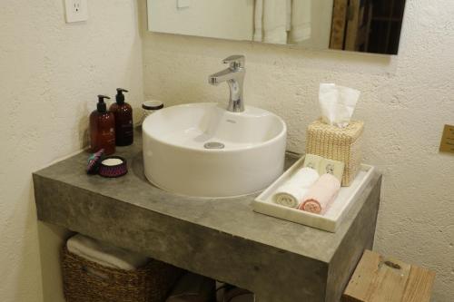a bathroom counter with a sink and towels on it at Orchid House San Miguel de Allende in San Miguel de Allende
