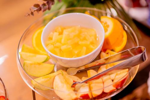 a plate with a bowl of fruit and a bowl of pineapple at Hotel Expo Stockholm in Stockholm