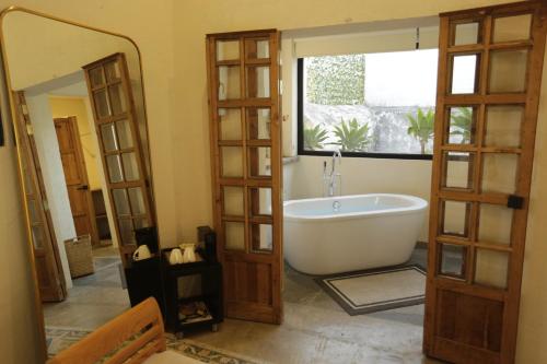a bathroom with a bath tub in a room at Orchid House San Miguel de Allende in San Miguel de Allende