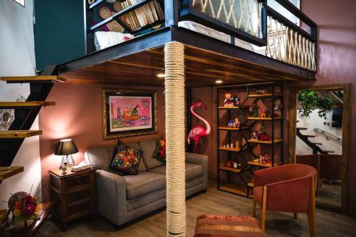 a living room with a tree house with a couch at “Encantador Loft” - en el corazón de San Pedro in Guadalajara