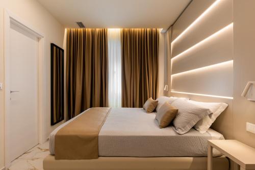 a bedroom with a bed and a window with curtains at Bologna Centrale 1 in Bologna