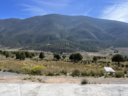 a view of a mountain with a house in the foreground at Camping en la Sierra de Arteaga in Los Lirios