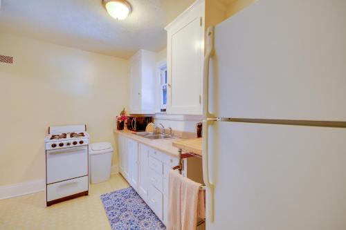 a kitchen with white cabinets and a refrigerator at WFH-Friendly Billings Apt about 1 Mi to Downtown! in Billings