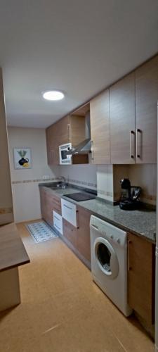a kitchen with a washing machine in the middle at Apartamento San Miguel in Baena