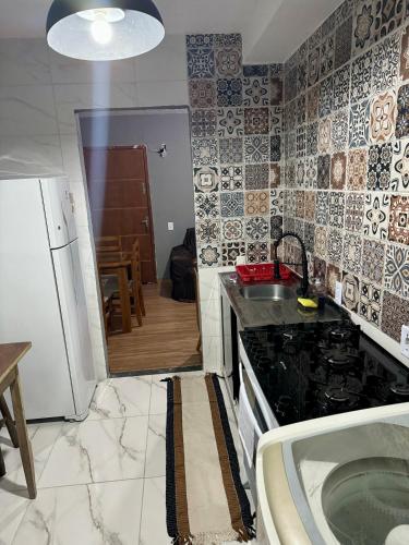 a kitchen with a sink and a counter top at Apartamento Apoteose Sambódromo in Rio de Janeiro