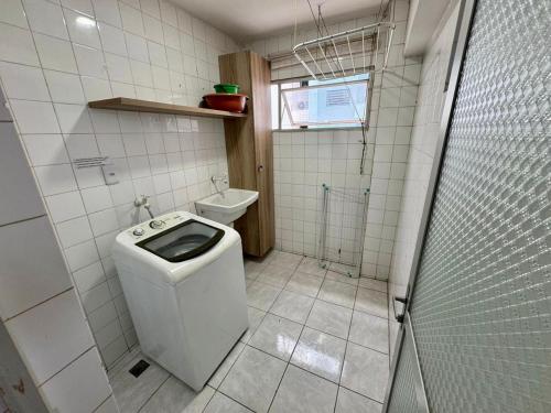 a small bathroom with a toilet and a shower at Beira-mar na praia pajuçara Dois quartos - Apto 302 in Maceió