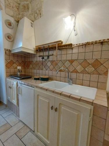 a kitchen with a sink and a counter top at Ziella Home in Ostuni