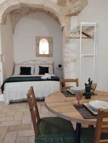 a bedroom with a bed and a table and a bed at Ziella Home in Ostuni