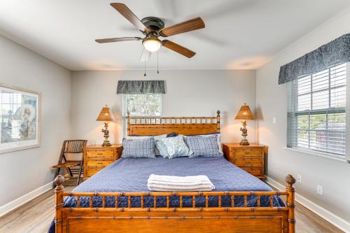 a bedroom with a wooden bed and a ceiling fan at Cottage with St Andrews Bay Views, Deck and Porch! in Panama City