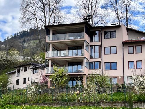 an apartment building with windows on a hill at Penthouse Sarajevo in Sarajevo